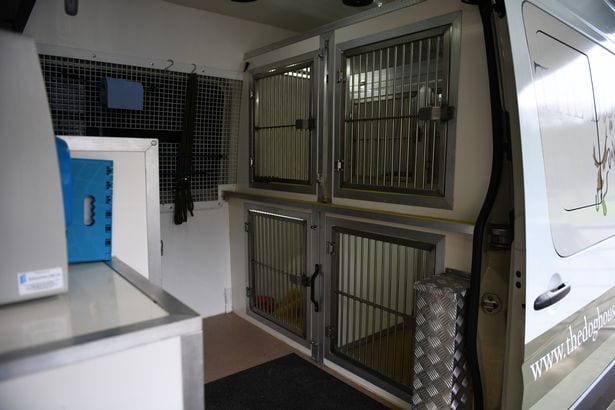 The specially designed van which takes dogs to and from the centre.